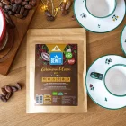 Ceremoniální kakao Pure BIO RAW – balení na stole s hrníčky a kakaovými boby, příprava kakaového rituálu